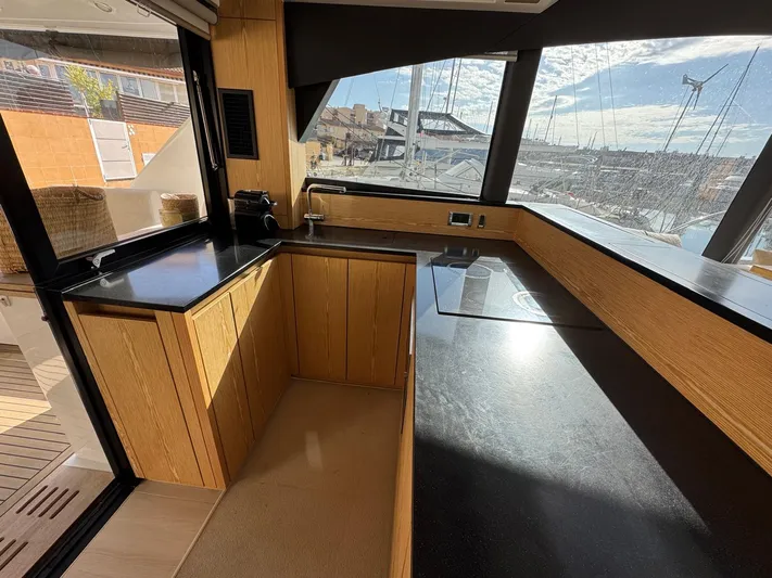 Sealine C530 Yacht Photos Pics Modern kitchen interior on 2017 Sealine C530 yacht with sleek countertops and panoramic windows.