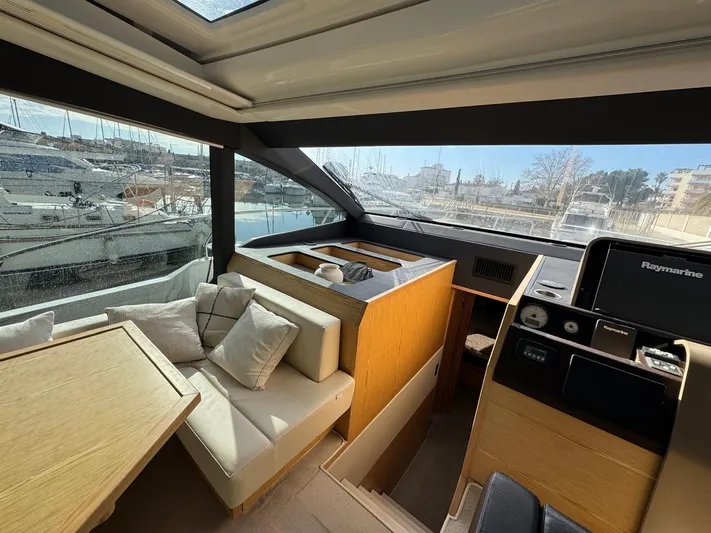 Sealine C530 Yacht Photos Pics Interior of 2017 Sealine C530 yacht with modern seating and helm, docked at marina.