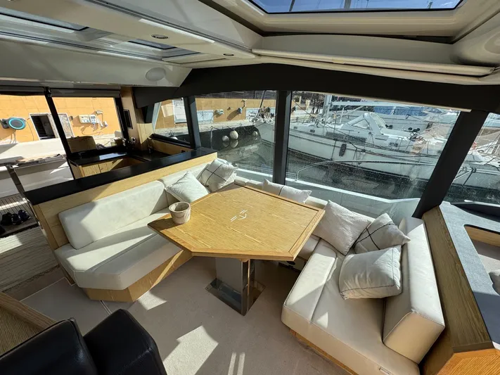 Sealine C530 Yacht Photos Pics Luxurious interior of 2017 Sealine C530 yacht with elegant seating and panoramic windows.