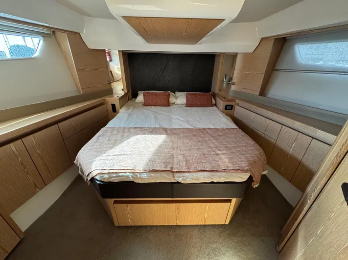 Sealine C530 Yacht Photos Pics Luxurious bedroom interior of 2017 Sealine C530 yacht with modern design and cozy bedding.