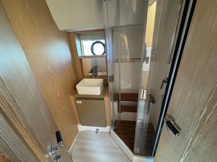 Sealine C530 Yacht Photos Pics Bathroom interior of 2017 Sealine C530 yacht with modern sink and glass shower.
