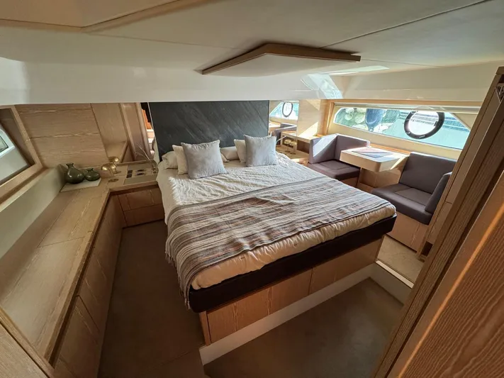 Sealine C530 Yacht Photos Pics Luxurious bedroom interior of 2017 Sealine C530 yacht with cozy bed and seating area.