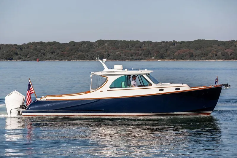 Carol I Yacht Photos Pics 2024 Hinckley 35 boat cruising on calm water with scenic background.