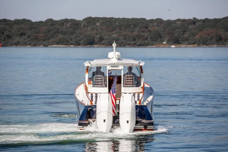 Carol I Yacht Photos Pics 2024 Hinckley 35 boat cruising on calm water with scenic forest backdrop.