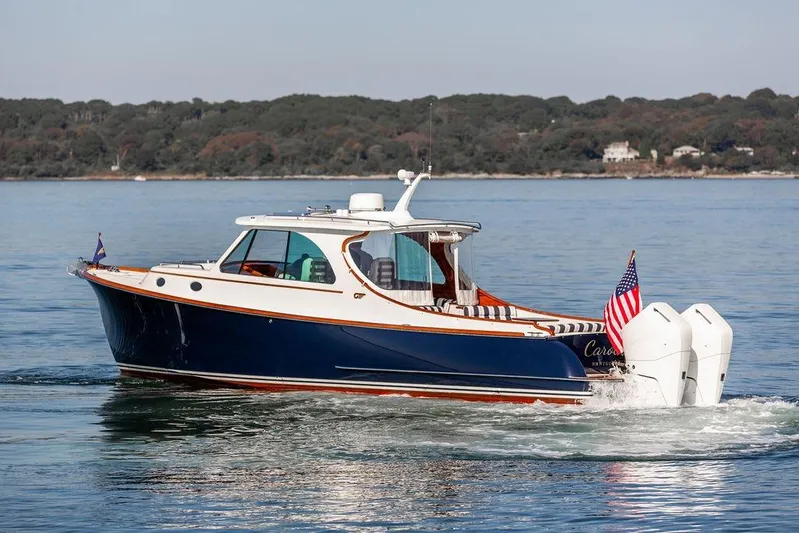 Carol I Yacht Photos Pics 2024 Hinckley 35 boat cruising on calm waters with American flag.