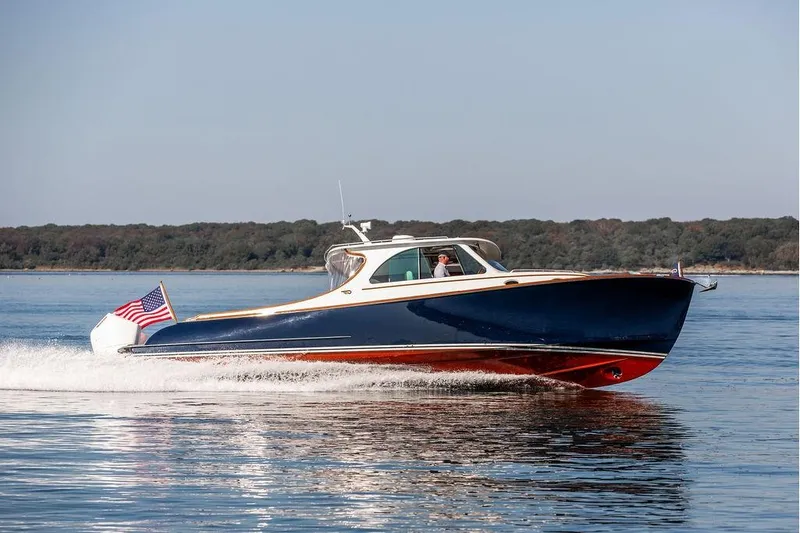 Carol I Yacht Photos Pics 2024 Hinckley 35 boat cruising on calm water with American flag.