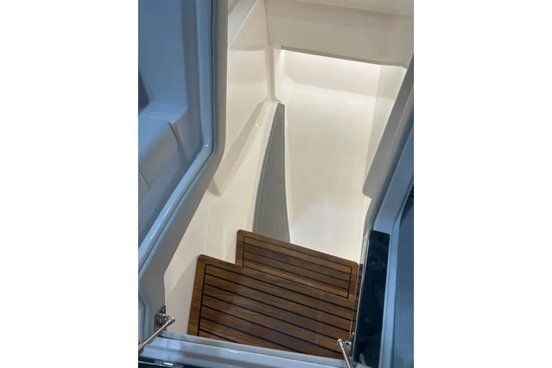  Yacht Photos Pics Staircase inside 2025 Regal LS36 boat with wooden steps and sleek design.
