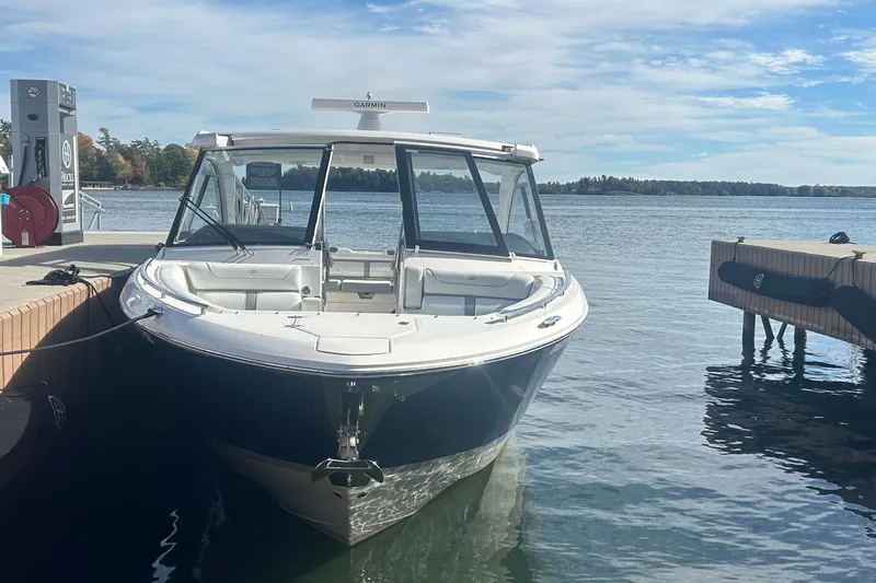  Yacht Photos Pics 2025 Regal LS36 boat docked by a serene lake under a clear sky.