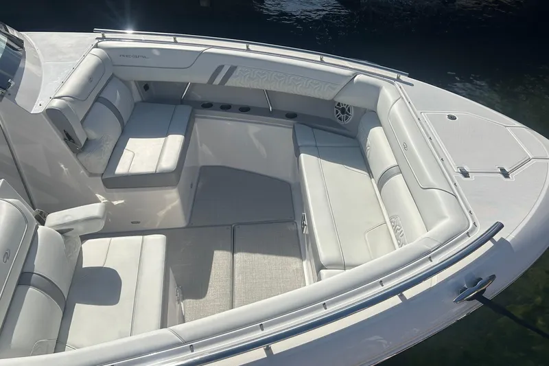  Yacht Photos Pics Luxurious seating area on a 2025 Regal LS36 boat, featuring elegant white upholstery.