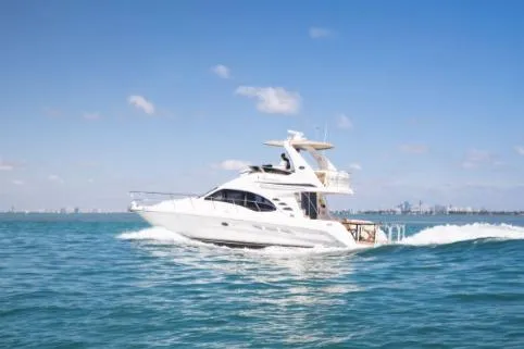 Salty Pause Yacht Photos Pics 2005 Sea Ray 420 Sedan Bridge yacht cruising on open water under clear skies.