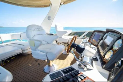 Salty Pause Yacht Photos Pics 2005 Sea Ray 420 Sedan Bridge yacht helm with luxurious seating and advanced navigation controls.
