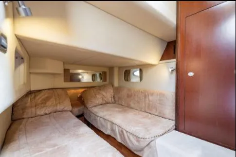 Salty Pause Yacht Photos Pics 2005 Sea Ray 420 Sedan Bridge cabin interior with twin beds and wooden cabinetry.