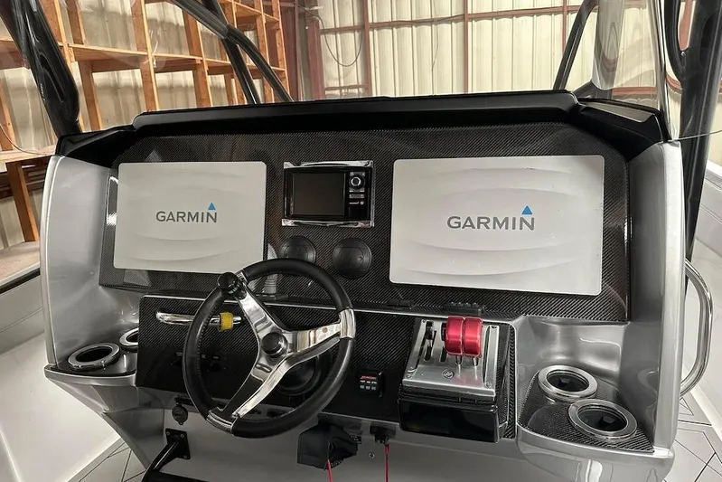  Yacht Photos Pics 2017 Nor-Tech 340 Sport Center Console dashboard with Garmin displays and steering wheel.