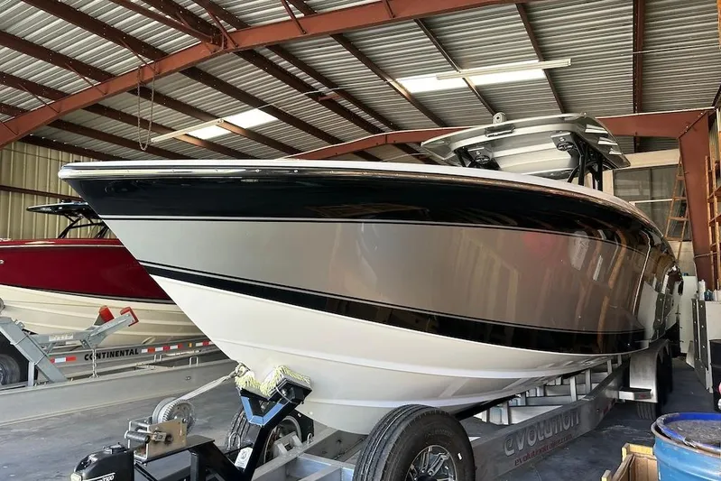  Yacht Photos Pics 2017 Nor-Tech 340 Sport Center Console boat in storage, sleek design, black and white hull.
