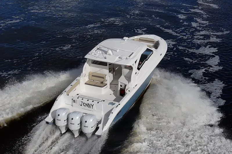  Yacht Photos Pics 2019 Pursuit DC 365 Dual Console boat cruising on water with triple engines.