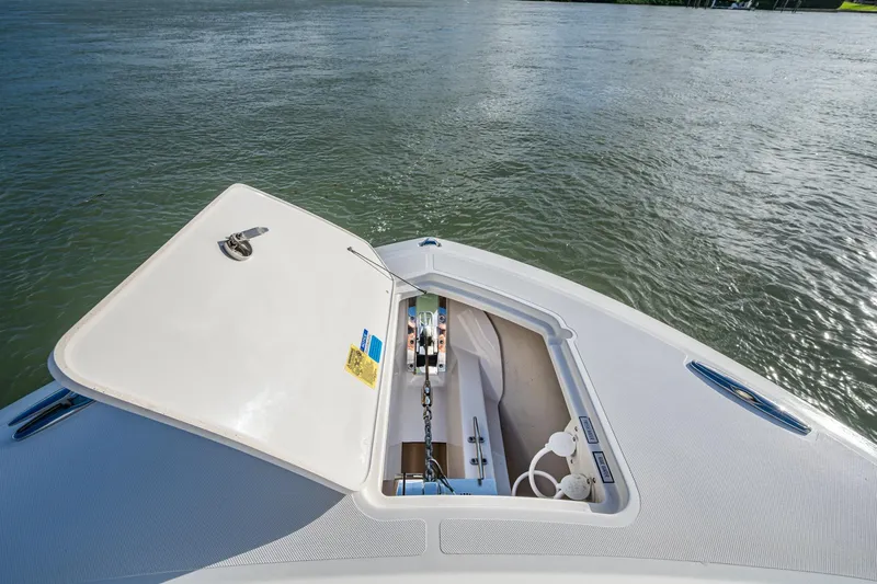  Yacht Photos Pics 2019 Pursuit DC 365 Dual Console boat with open storage compartment on calm water.