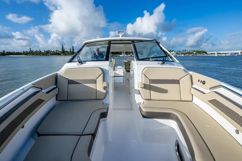  Yacht Photos Pics 2019 Pursuit DC 365 Dual Console boat interior with spacious seating on a sunny day.