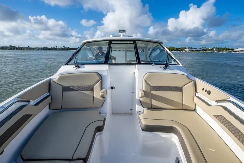  Yacht Photos Pics 2019 Pursuit DC 365 Dual Console boat interior with beige seating on a sunny day.