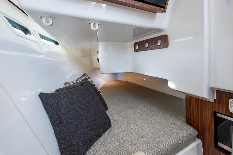  Yacht Photos Pics 2019 Pursuit DC 365 Dual Console cabin interior with cozy bedding and modern design.