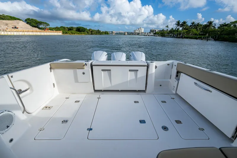  Yacht Photos Pics 2019 Pursuit DC 365 Dual Console boat deck with scenic waterway view.