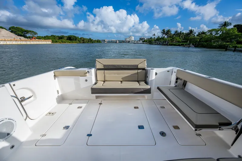  Yacht Photos Pics 2019 Pursuit DC 365 Dual Console boat interior with seating, on a scenic waterway.