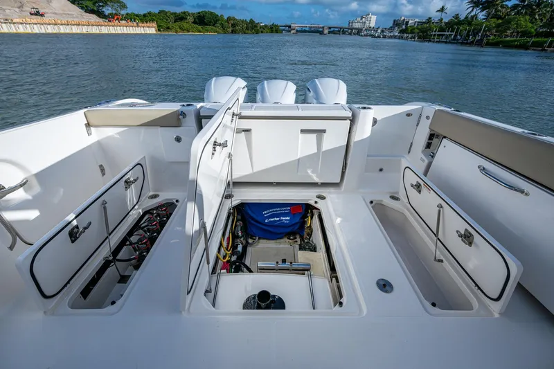  Yacht Photos Pics 2019 Pursuit DC 365 Dual Console boat with open storage compartments on deck.
