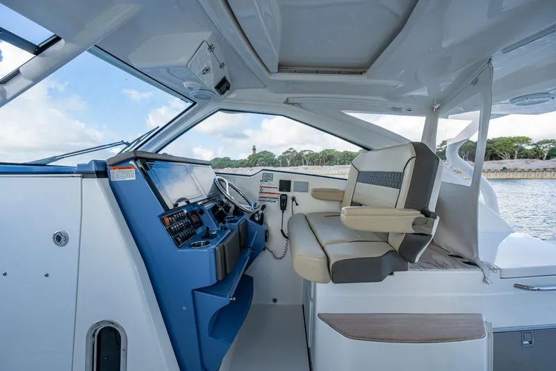  Yacht Photos Pics 2019 Pursuit DC 365 Dual Console boat interior with helm and seating.