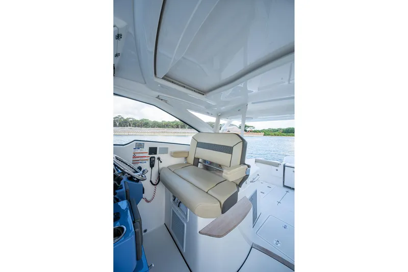  Yacht Photos Pics 2019 Pursuit DC 365 Dual Console interior with helm seat and dashboard view.