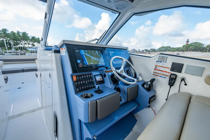  Yacht Photos Pics 2019 Pursuit DC 365 Dual Console boat cockpit with navigation system and steering wheel.