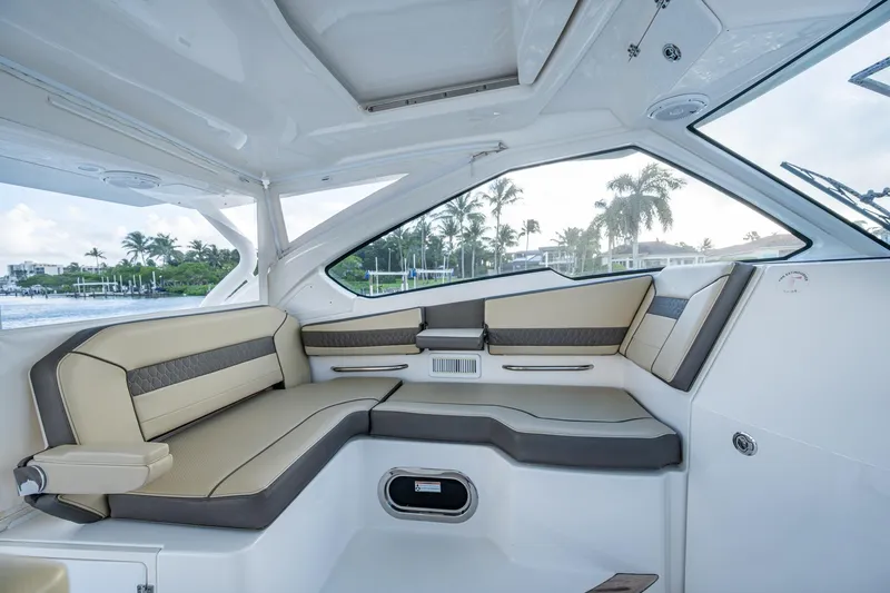  Yacht Photos Pics 2019 Pursuit DC 365 Dual Console interior with luxurious seating and scenic waterfront view.