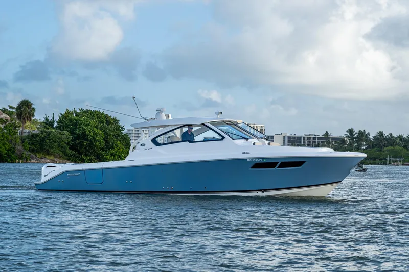  Yacht Photos Pics 2019 Pursuit DC 365 Dual Console boat cruising on a calm waterway.