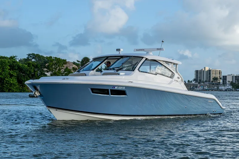  Yacht Photos Pics 2019 Pursuit DC 365 Dual Console boat cruising on a calm waterway.