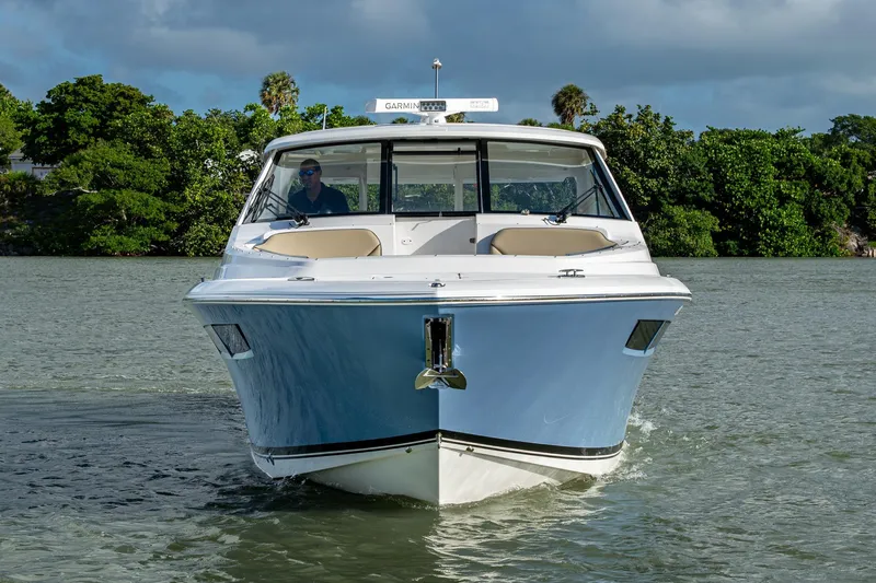  Yacht Photos Pics 2019 Pursuit DC 365 Dual Console boat cruising on a scenic waterway.