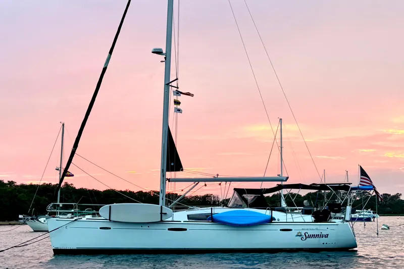 Sunniva Yacht Photos Pics 2007 Beneteau Oceanis 46 sailboat at sunset with pink sky and calm waters.