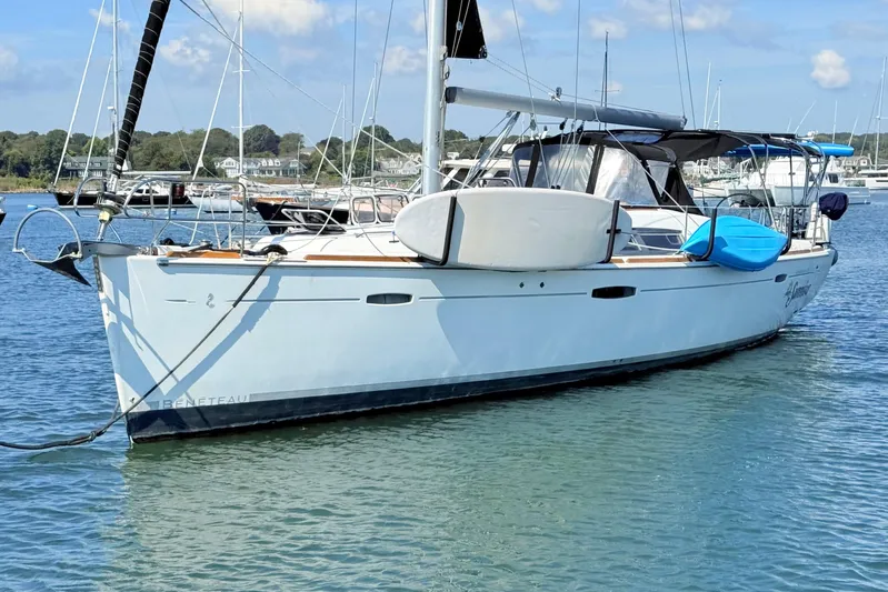 Sunniva Yacht Photos Pics 2007 Beneteau Oceanis 46 sailboat anchored in a marina, featuring a sleek design and calm waters.