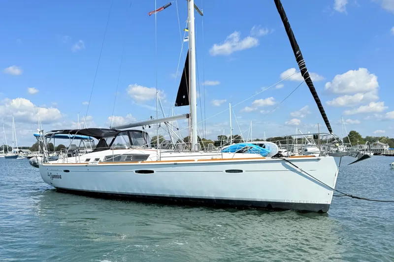 Sunniva Yacht Photos Pics 2007 Beneteau Oceanis 46 sailboat on calm water under blue sky.