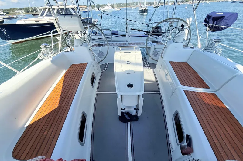 Sunniva Yacht Photos Pics Cockpit of 2007 Beneteau Oceanis 46 sailboat with dual steering wheels and wooden seating.