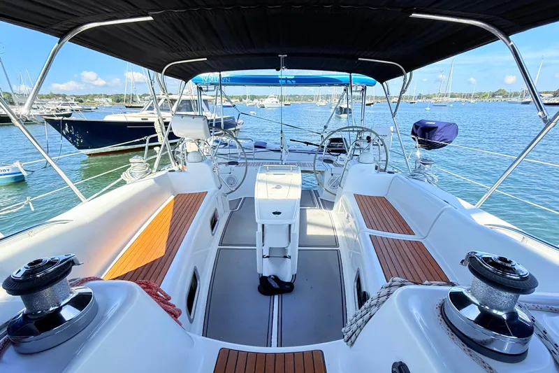 Sunniva Yacht Photos Pics Cockpit of 2007 Beneteau Oceanis 46 sailboat with dual steering wheels and teak seating.