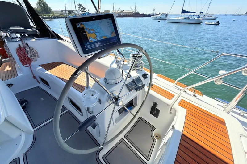 Sunniva Yacht Photos Pics Cockpit of 2007 Beneteau Oceanis 46 sailboat with navigation equipment and scenic harbor view.