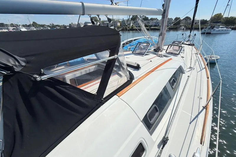 Sunniva Yacht Photos Pics 2007 Beneteau Oceanis 46 sailboat deck with black canopy, docked in marina.