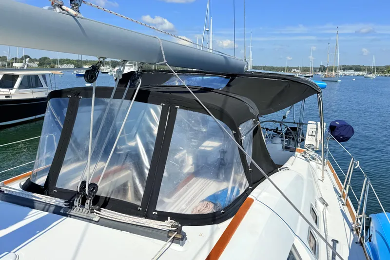 Sunniva Yacht Photos Pics 2007 Beneteau Oceanis 46 sailboat with black canopy, docked in a marina.