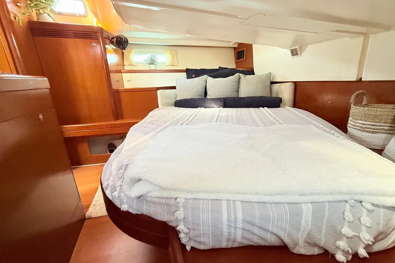 Sunniva Yacht Photos Pics Cozy cabin interior of 2007 Beneteau Oceanis 46 yacht with plush bedding and wooden accents.