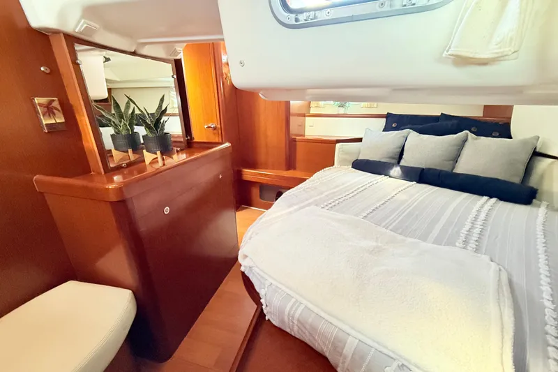 Sunniva Yacht Photos Pics Luxurious cabin interior of 2007 Beneteau Oceanis 46 yacht with cozy bedding and plants.