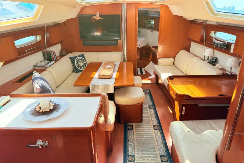 Sunniva Yacht Photos Pics Luxurious interior of 2007 Beneteau Oceanis 46 yacht with elegant seating and wooden finishes.