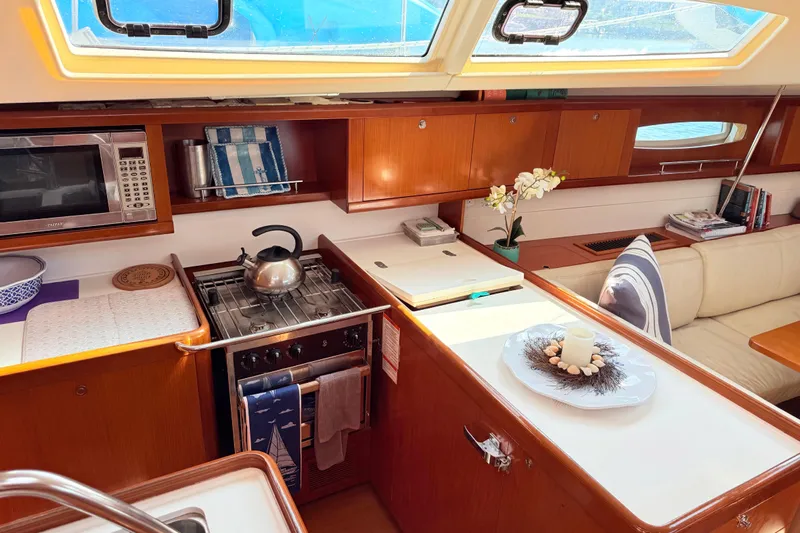 Sunniva Yacht Photos Pics Interior of 2007 Beneteau Oceanis 46 yacht with kitchen and seating area.