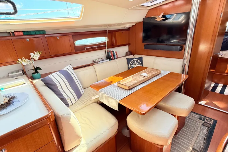 Sunniva Yacht Photos Pics Luxurious interior of 2007 Beneteau Oceanis 46 yacht with cozy seating and elegant decor.