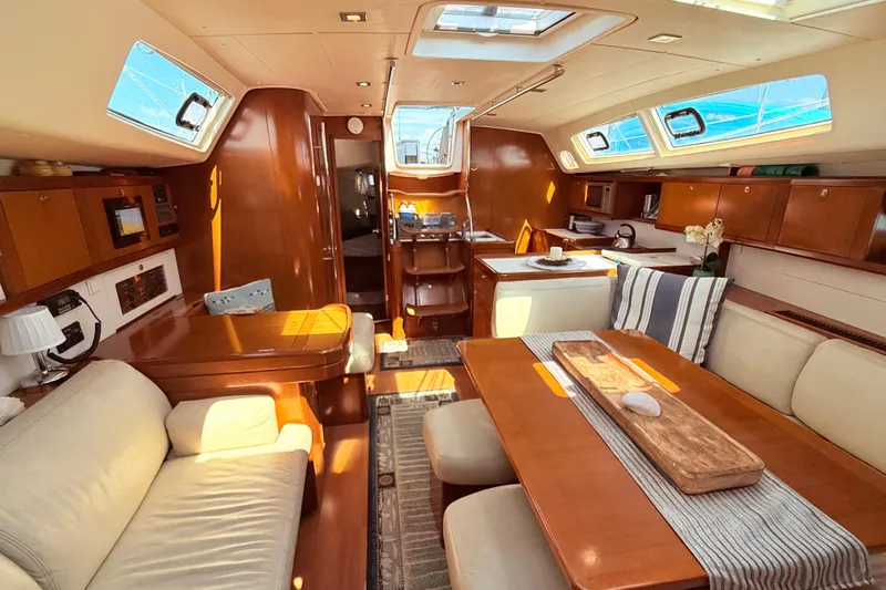 Sunniva Yacht Photos Pics Luxurious interior of 2007 Beneteau Oceanis 46 yacht with elegant wood finish and cozy seating.