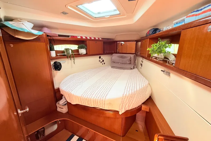 Sunniva Yacht Photos Pics Luxurious cabin interior of 2007 Beneteau Oceanis 46 yacht with cozy bed and wooden finish.