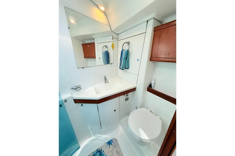 Sunniva Yacht Photos Pics Bathroom interior of 2007 Beneteau Oceanis 46 yacht, featuring sink, mirror, and toilet.