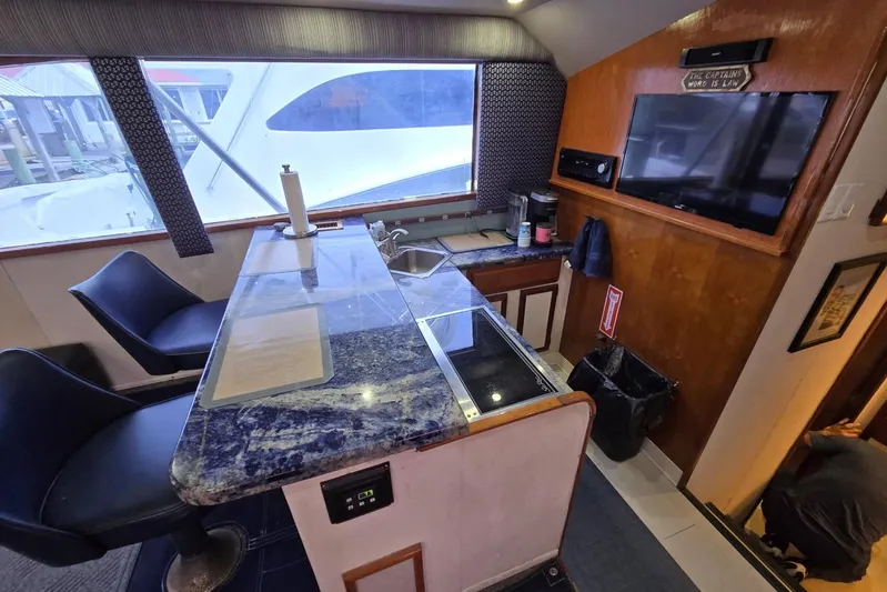  Yacht Photos Pics Interior of 1988 Topaz 44 Flybridge yacht with kitchen and seating area.